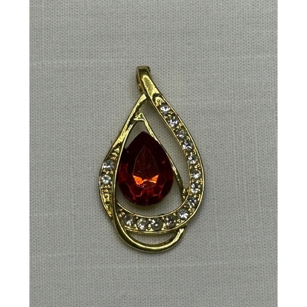Gold tone red gem & rhinestone pendant